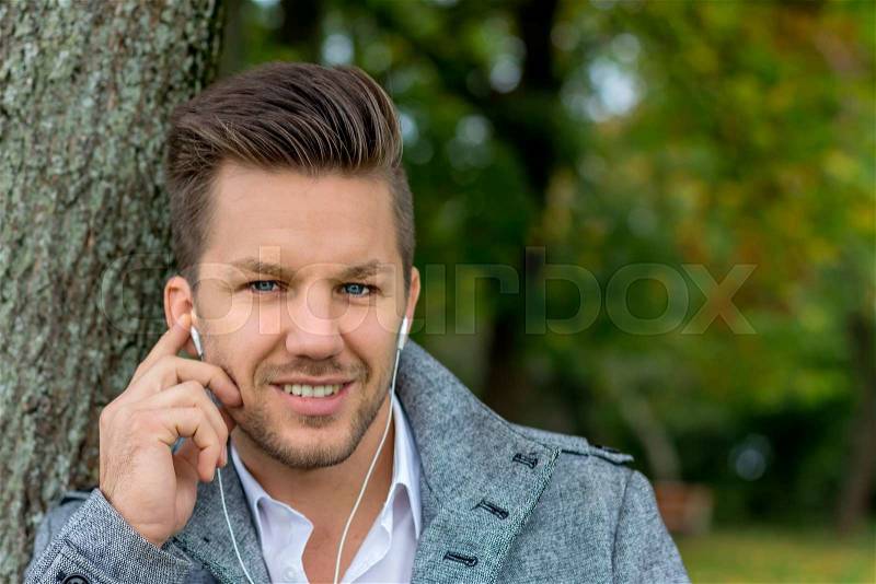 A man listens to music with your phone. talking on mobile phone, stock photo