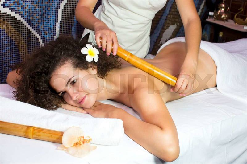 Japanese massage with bamboo sticks in the spa salon, stock photo