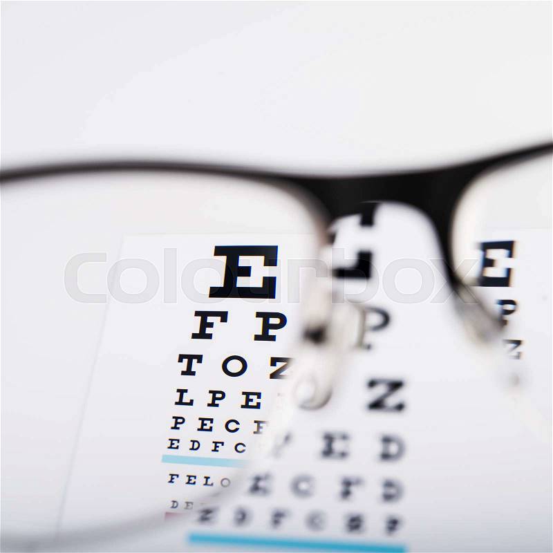 Eye chart and glasses on background, stock photo