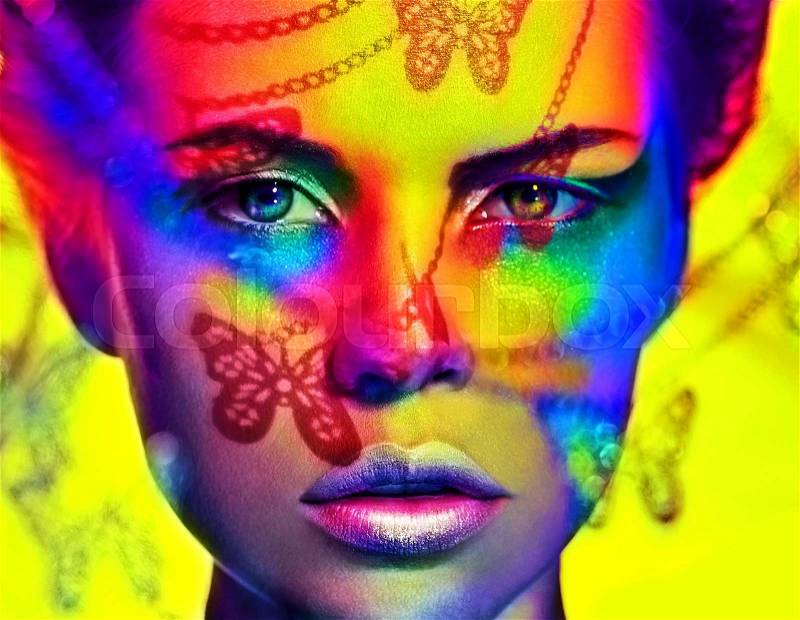 Close up portrait of woman color face art makeup.Bright cosmetics.Butterfly shadow, stock photo