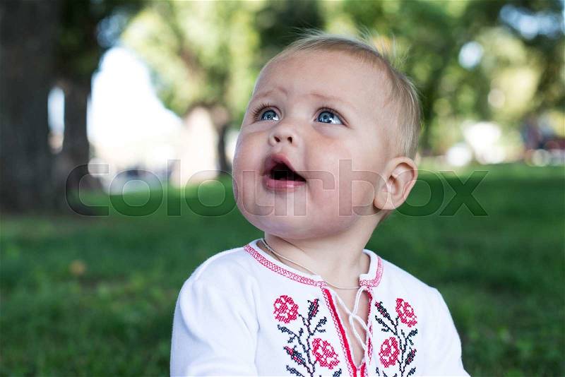 Funny kid with the big eyes close up. on grean background, stock photo