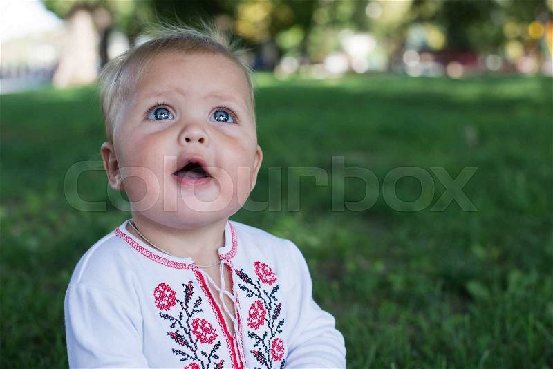 Funny kid with the big eyes close up. on grean background, stock photo