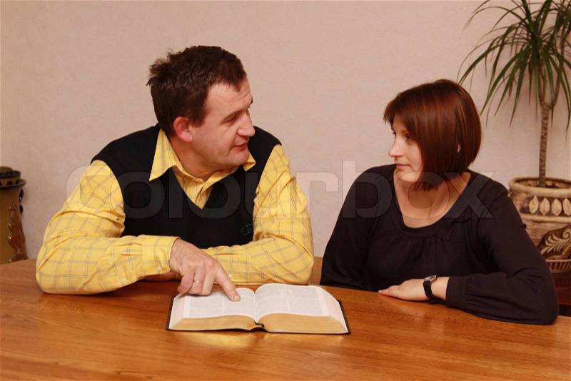 Man and woman reading Bible, stock photo