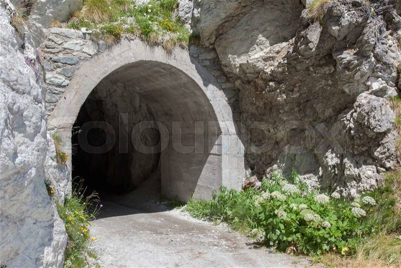 Small dark tunnel in a Swiss mountain, stock photo