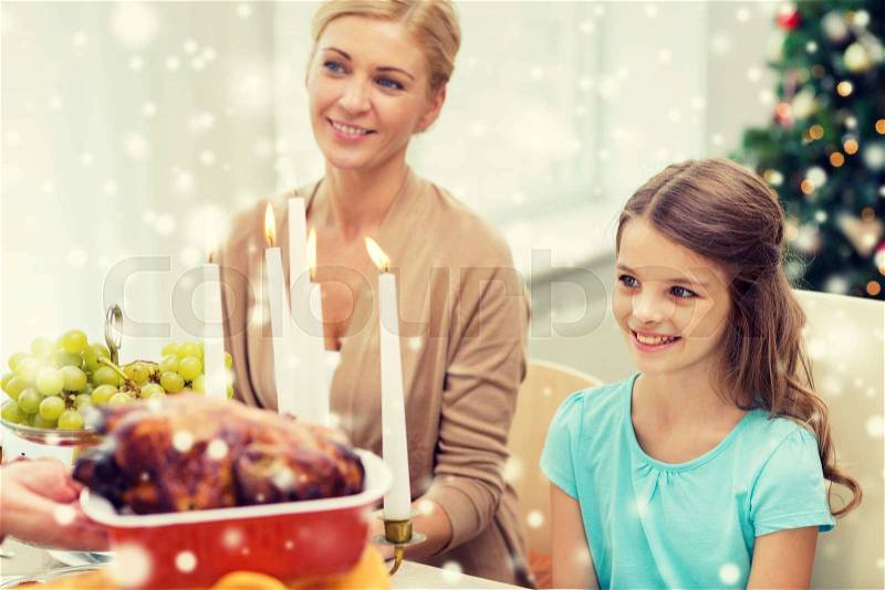 Family, holidays, christmas and people concept - smiling family having dinner at home, stock photo