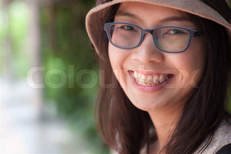 Clouse up face asia woman.joy and smile woman wear hat and eyeglasses, stock photo