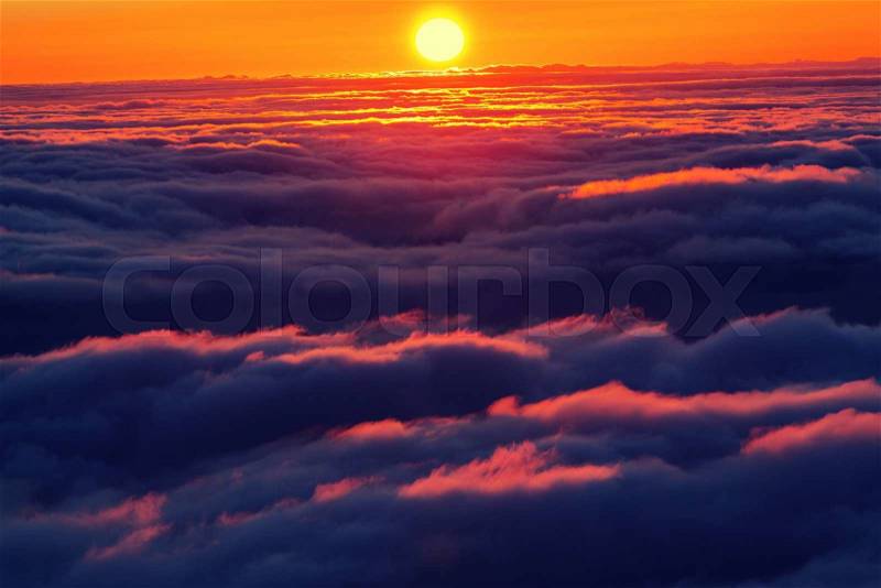 Beautiful sunset on the hill above clouds, stock photo