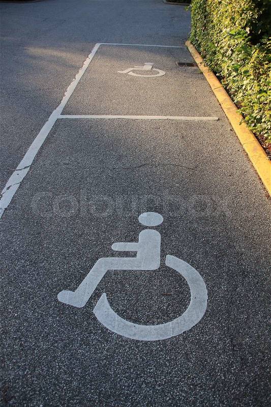 Parking places for disabled people and a wheelchair before the hotel in the village Kolding in Denmark, stock photo