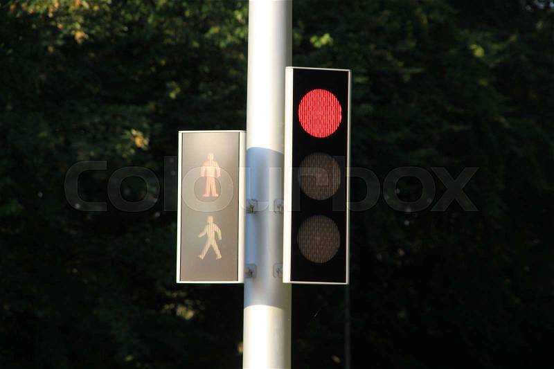 Traffic light is red for the cars and the pedestrians at the intersection in the village Kolding in Denmark, stock photo