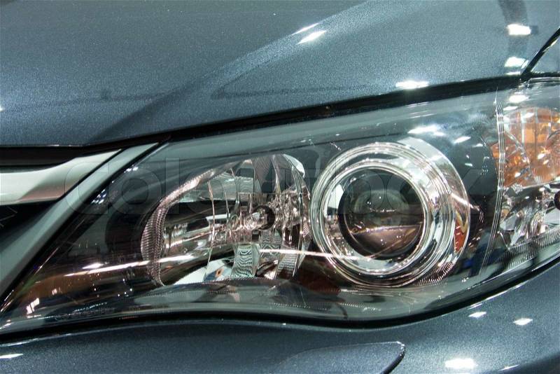 Close-up of a grey modern car head lamp, stock photo