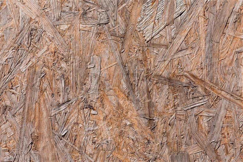 Old plywood recycled compressed wood chippings board background texture, stock photo