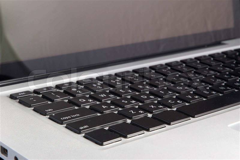 Aluminium laptop with desktop on black background, stock photo