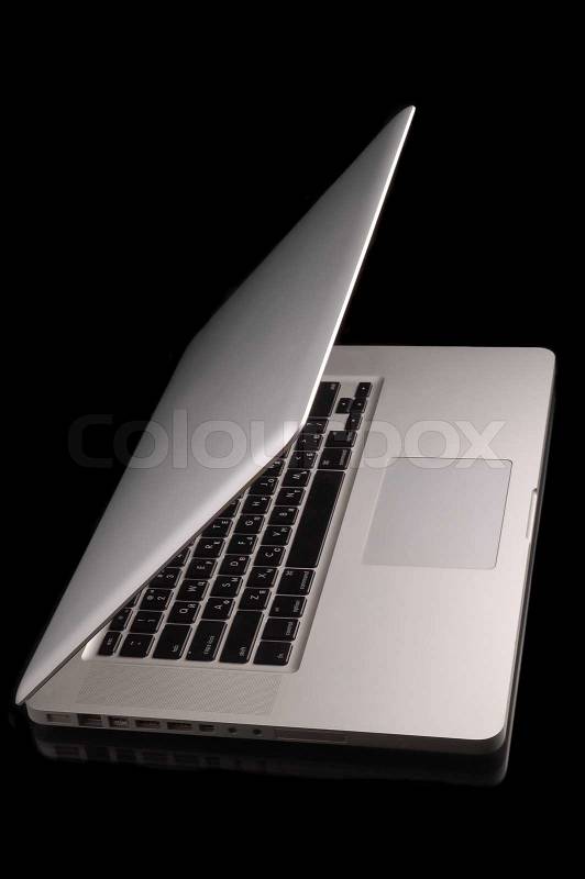 Aluminium laptop with desktop on black background, stock photo