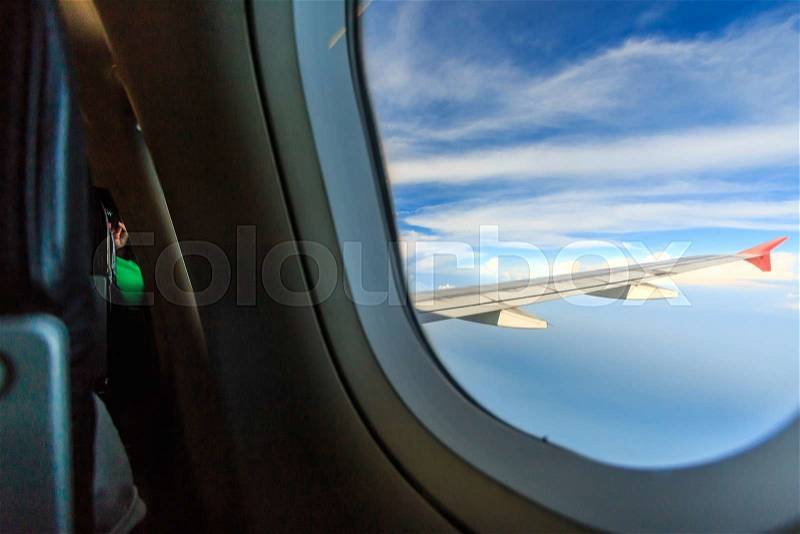 Scenery clouds and sky as seen through window of an aircraft, stock photo