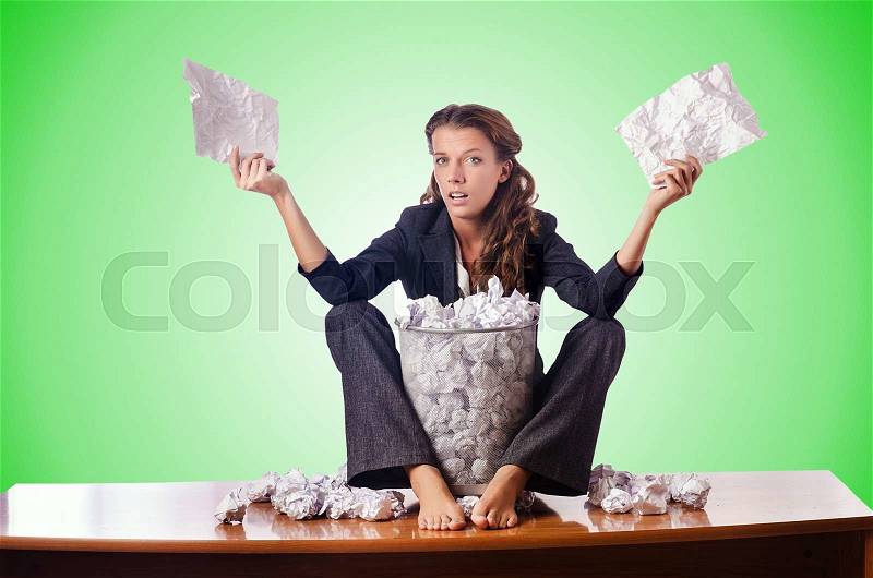 Woman with lots of discarded paper, stock photo