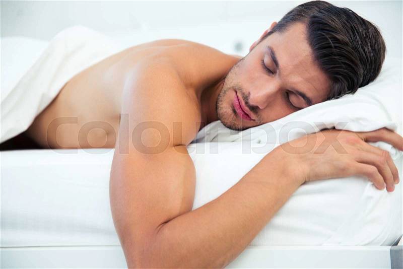 Portrait of a man sleeping in the bed at home, stock photo