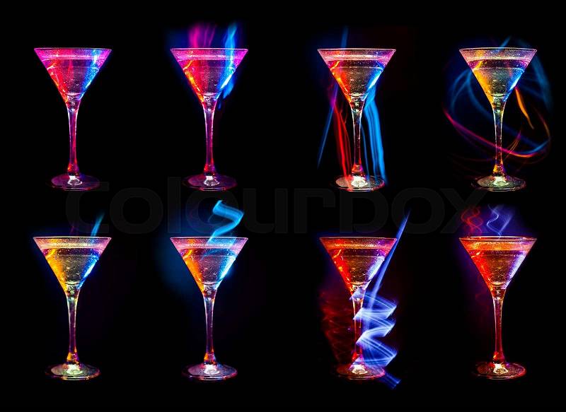 Colorful Bright fresh modern cocktails in glasses on black background with reflection, stock photo