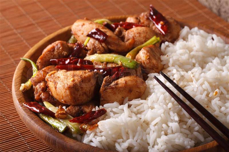 Chinese Cuisine: kung pao chicken and rice on a plate close-up. horizontal , stock photo