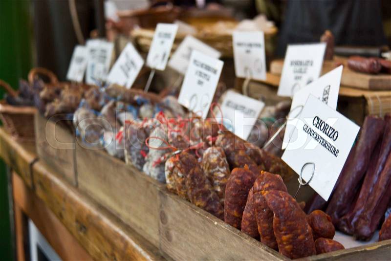 Cured sausages for sale at the deli market, stock photo
