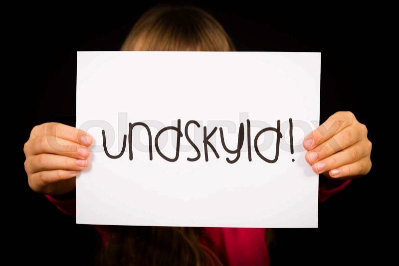Studio shot of child holding a sign with Danish word Undskyld - Sorry, stock photo