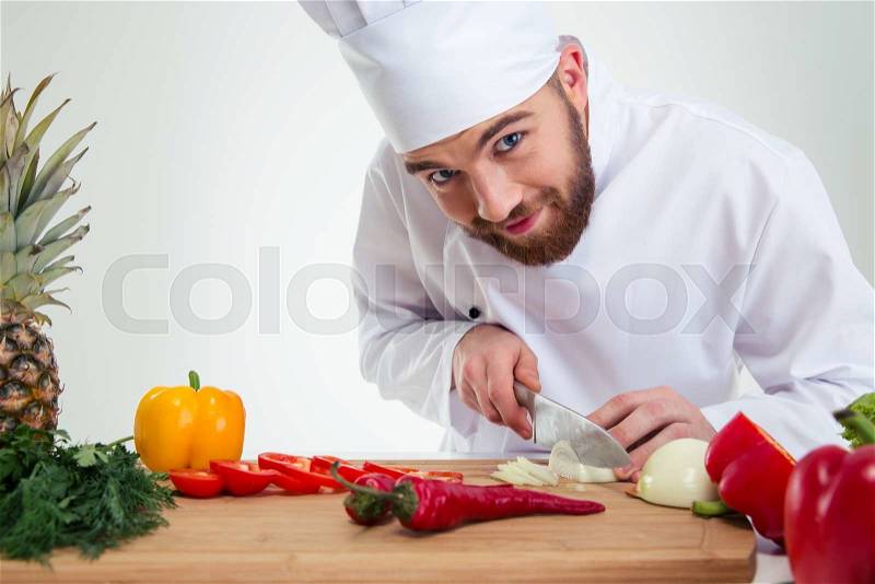 Portrait of a handsome male chef cook cutting vegetables , stock photo