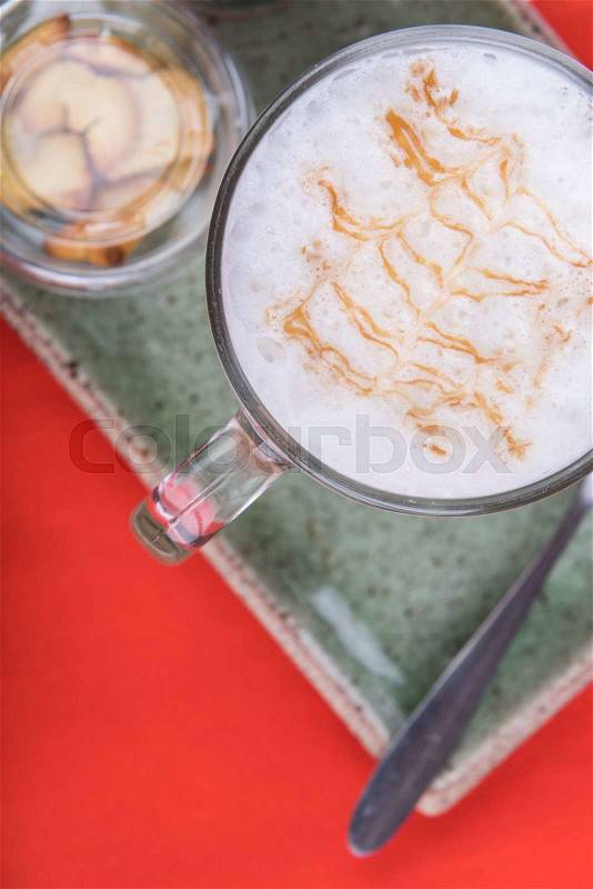 Cup of coffee and biscuits on green clay background, stock photo