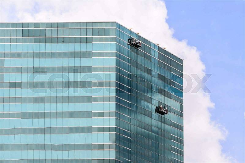 Group of Workers Cleaning Windows Service on High Rise Building, stock photo