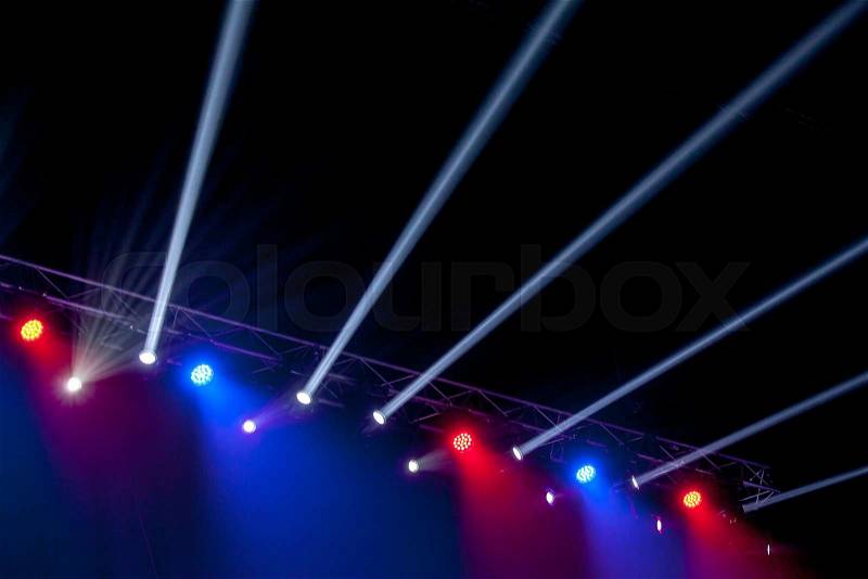 Red and blue stage lights with rays on black background, stock photo