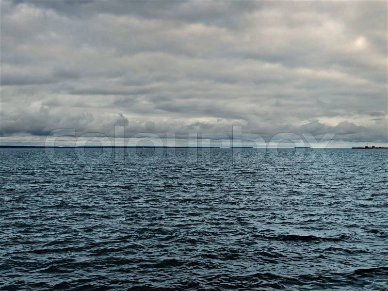 Dark lake before storm over rain clouds, stock photo
