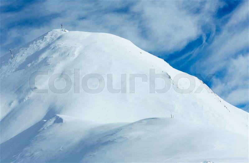 Winter Silvretta Alps with cross on mount top. Tyrol, Austria, stock photo