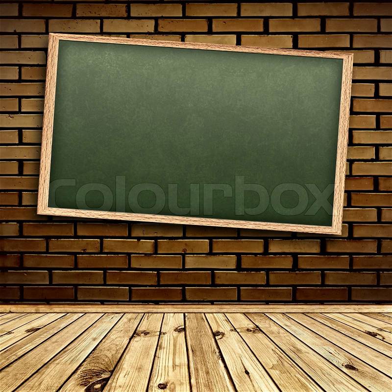 Empty school blackboard at brick wall in interior with wooden floor, stock photo