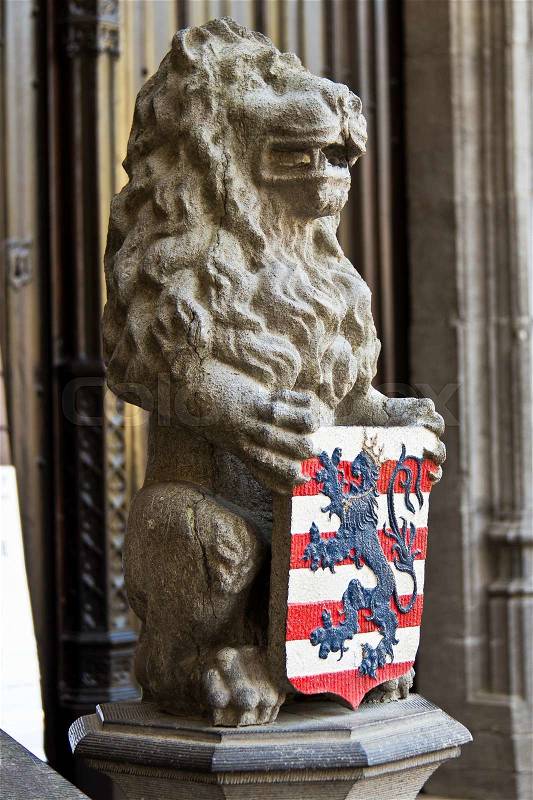 Lion statue with coat of arms shield, stock photo