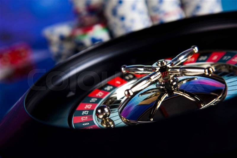 Poker Chips on a gaming with casino roulette, stock photo