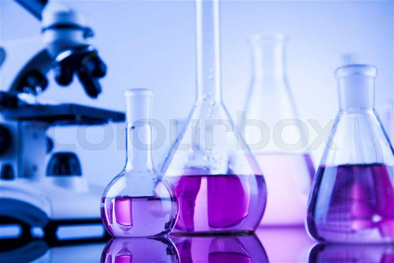 Laboratory work place with microscope and glassware, stock photo