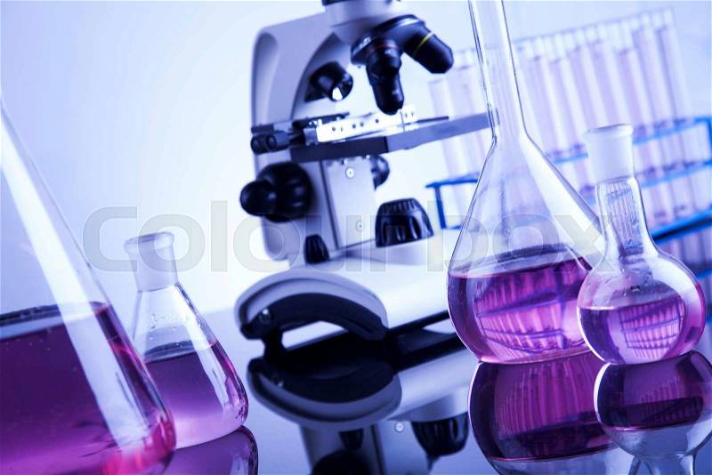 Laboratory work place with microscope and glassware, stock photo