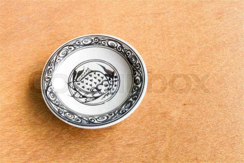 Old dish on wooden background, stock photo