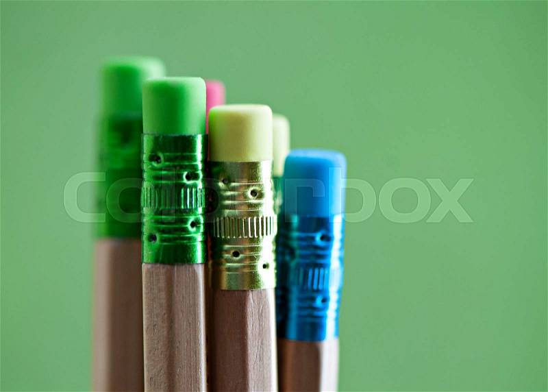 Row of color pencils on green background.art.Creativity, stock photo