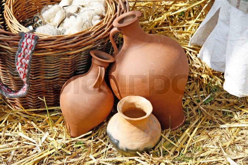 Handmade clay pots on straw - outdoor shot, stock photo