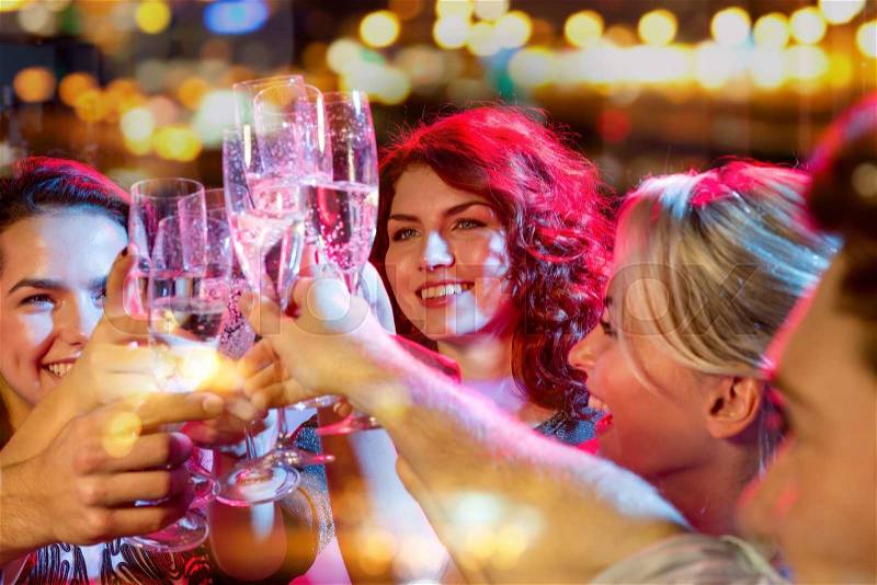 Party, holidays, celebration, nightlife and people concept - smiling friends with glasses of champagne in club, stock photo
