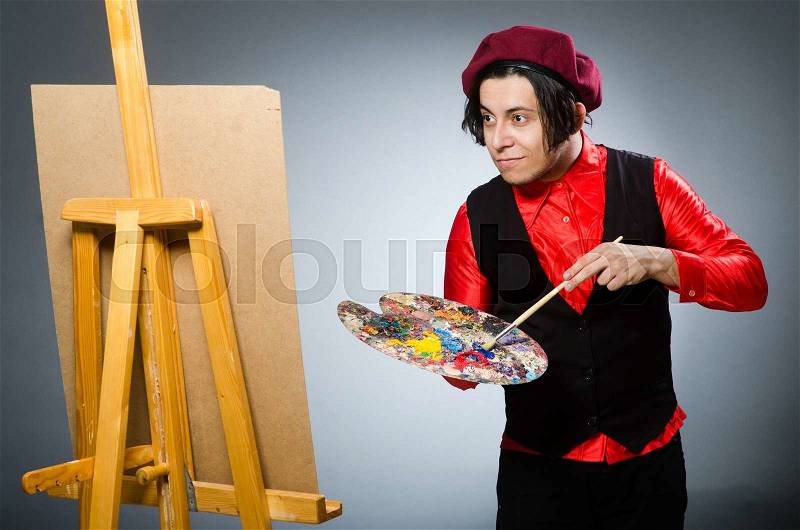 Funny artist in dark studio, stock photo
