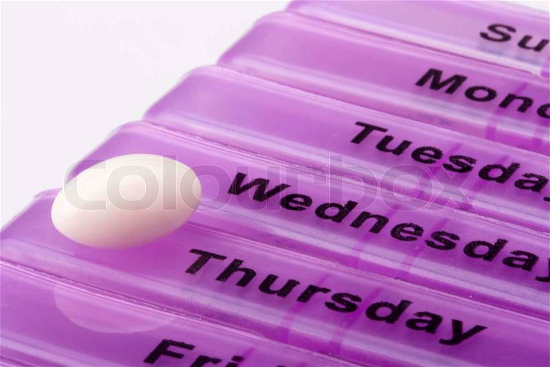 Box for medications showing days of the week, stock photo