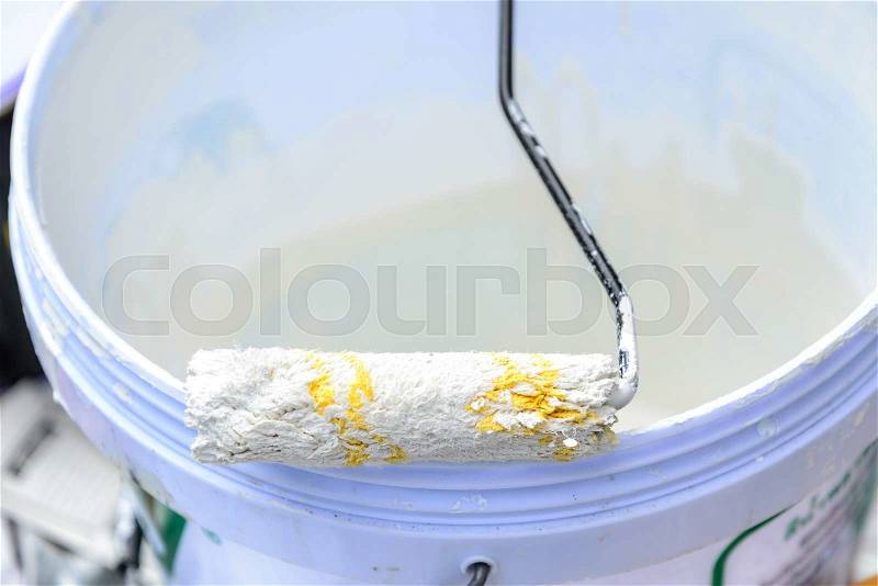 White color in bucket for paint wall with paint roller, stock photo