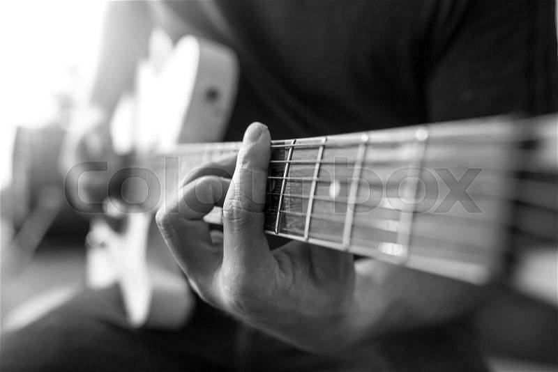 Closeup of finger play the guitar,Black and white filter, stock photo