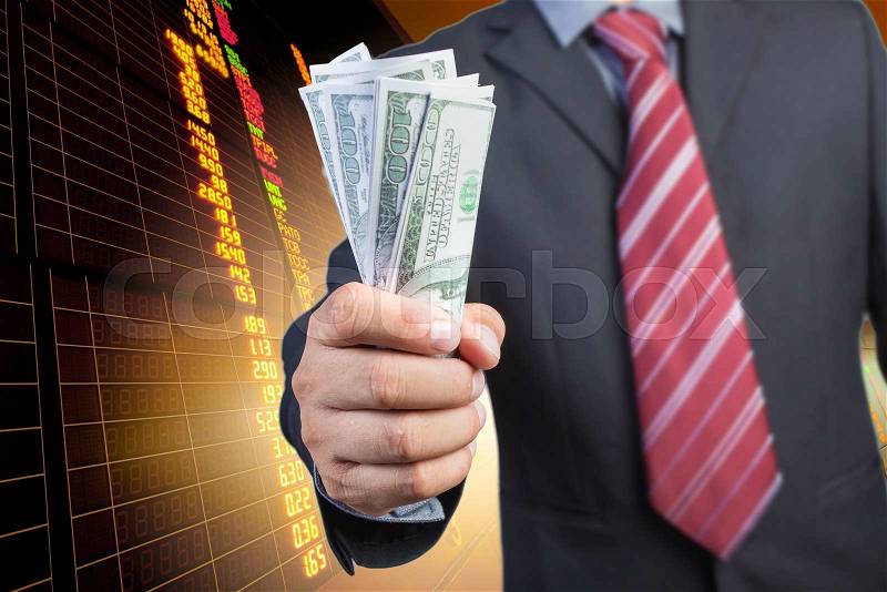 Businessman hand gripping money, US dollar (USD) bills - investment, business concepts, stock photo