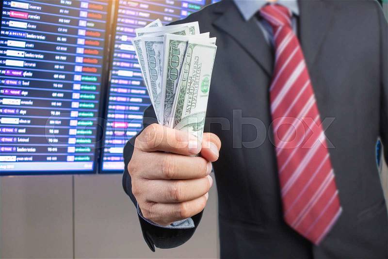 Businessman hand gripping money, US dollar (USD) bills - investment, business concepts, stock photo