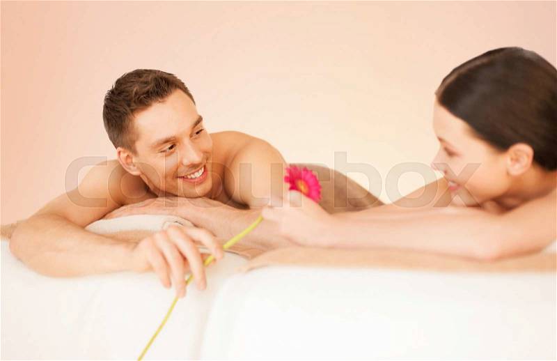 Picture of couple in spa salon lying on the massage desks, stock photo