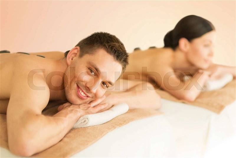 Picture of couple in spa salon with hot stones, stock photo