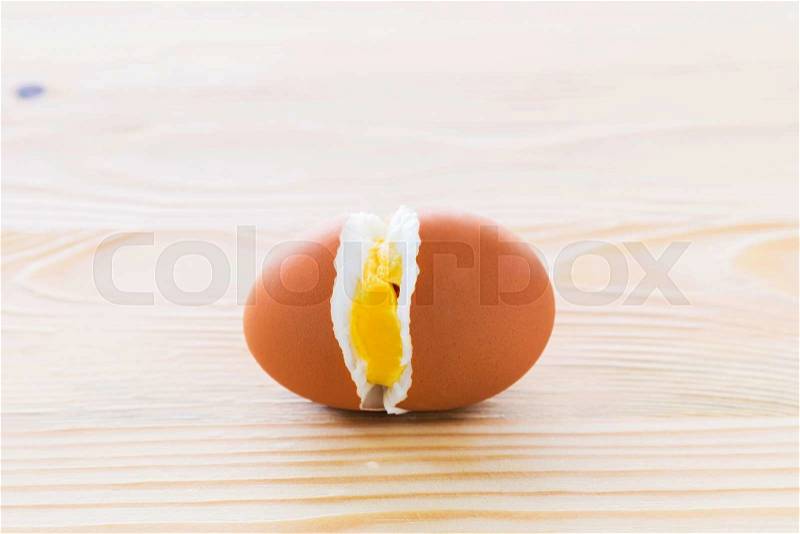 Cracked eggs in the middle on the wooden floor, stock photo