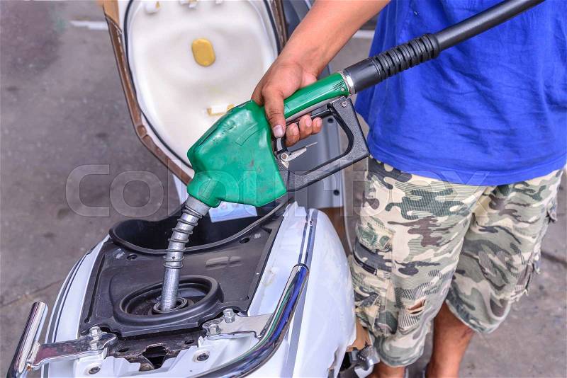 Oil fueling to motorcycles, stock photo