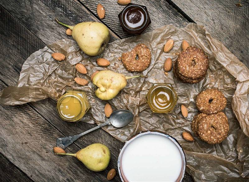 Tasty Pears almonds Cookies and milk on rustic wood. Rustic style and autumn food photo, stock photo